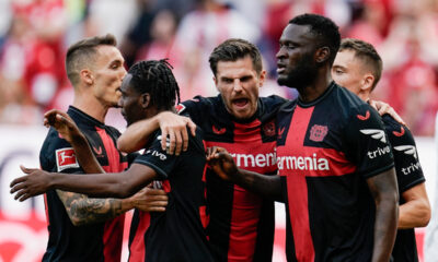 Leverkusen's players celebrate after Mainz's Sepp van den Berg scored an own goal, during a German Bundesliga soccer match between FSV Mainz 05 and Bayer Leverkusen, at the Mewa Arena in Mainz, Germany, Saturday Sept. 30, 2023. (Uwe Anspach/dpa via AP)