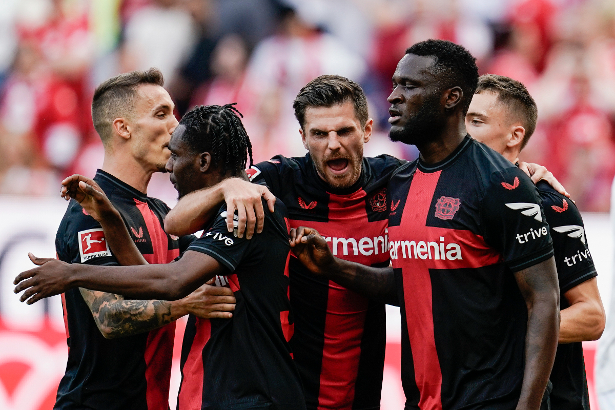 Leverkusen's players celebrate after Mainz's Sepp van den Berg scored an own goal, during a German Bundesliga soccer match between FSV Mainz 05 and Bayer Leverkusen, at the Mewa Arena in Mainz, Germany, Saturday Sept. 30, 2023. (Uwe Anspach/dpa via AP)