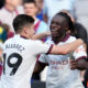 Manchester City's Jeremy Doku celebrates with Julian Alvarez, left, after scoring his side's first goal during the English Premier League soccer match between West Ham United and Manchester City at London stadium in London, Saturday, Sept. 16, 2023. (AP Photo/Kin Cheung)