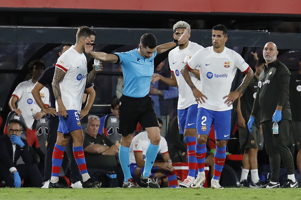 Referee gestures during a Spanish La Liga soccer match between Mallorca and Barcelona at the Son Moix stadium in Palma de Mallorca, Spain, Tuesday, Sept. 26, 2023. (AP Photo/Francisco Ubilla)
