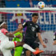 Bayern's Jamal Musiala, center, heads the ball pressured by Leipzig's Mohamed Simakan during the German Bundesliga soccer match between Leipzig and Bayern Munich, at the Red Bull Arena stadium in Leipzig, Germany, Saturday, Sept. 30, 2023. (AP Photo/Matthias Schrader)