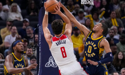 Indiana Pacers guard Tyrese Haliburton (0) blocks the shot of Washington Wizards forward Deni Avdija (8) during the first half of an NBA basketball game in Indianapolis, Wednesday, Oct. 25, 2023. (AP Photo/Michael Conroy)