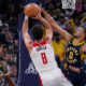 Indiana Pacers guard Tyrese Haliburton (0) blocks the shot of Washington Wizards forward Deni Avdija (8) during the first half of an NBA basketball game in Indianapolis, Wednesday, Oct. 25, 2023. (AP Photo/Michael Conroy)