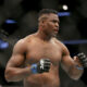 FILE - Francis Ngannou during a heavyweight championship mixed martial arts bout against Stipe Miocic at UFC 220, Sunday, Jan. 21, 2018, in Boston. Being the best heavyweight boxer in the world isn’t enough for Tyson Fury. He has appeared in WWE, been the subject of a Netflix reality series and is now in the Middle East to fight a former UFC star in the latest in a crossover bouts. Fighting Francis Ngannou on Saturday, Oct. 28, 2023 will earn Fury a reported $50 million. (AP Photo/Gregory Payan, File)