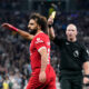 Referee Simon Hooper shows the yellow card to Liverpool's Mohamed Salah during the English Premier League soccer match between Tottenham Hotspur and Liverpool at the Tottenham Hotspur Stadium, in London, England, Saturday, Sept. 30, 2023. (AP Photo/Alberto Pezzali)