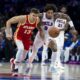 Atlanta Hawks' Bogdan Bogdanovic, left, and Philadelphia 76ers' Kelly Oubre Jr., right, chase after the ball during the second half of a preseason NBA basketball game, Friday, Oct. 20, 2023, in Philadelphia. (AP Photo/Chris Szagola)