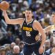 Denver Nuggets center Nikola Jokic, left, fields a pass as Utah Jazz forward Lauri Markkanen defends in the second half of an NBA basketball game, Monday, Oct. 30, 2023, in Denver. (AP Photo/David Zalubowski)