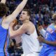 Denver Nuggets center Nikola Jokic, center, looks to score between Oklahoma City Thunder guards Josh Giddey (3) and Luguentz Dort (5) in the first half of an NBA basketball game, Sunday, Oct. 29, 2023, in Oklahoma City. (AP Photo/Nate Billings)