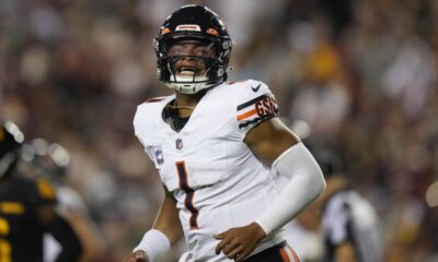 Chicago Bears quarterback Justin Fields (1) reacting after throwing a touchdown pass to wide receiver DJ Moore during the first half of an NFL football game against the Washington Commanders, Thursday, Oct. 5, 2023, in Landover, Md. (AP Photo/Alex Brandon)