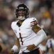 Chicago Bears quarterback Justin Fields (1) reacting after throwing a touchdown pass to wide receiver DJ Moore during the first half of an NFL football game against the Washington Commanders, Thursday, Oct. 5, 2023, in Landover, Md. (AP Photo/Alex Brandon)