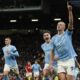 Manchester City's Erling Haaland, right, celebrates after scoring his side's opening goal from a penalty kick during the English Premier League soccer match between Manchester United and Manchester City at Old Trafford stadium in Manchester, England, Sunday, Oct. 29, 2023. (AP Photo/Dave Thompson)