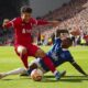 Liverpool's Luis Diaz, left, challenges for the ball with Everton's Ashley Young during the English Premier League soccer match between Liverpool and Everton, at Anfield in Liverpool, England, Saturday, Oct. 21, 2023. (AP Photo/Jon Super)