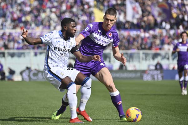 Atalanta's Jeremie Boga, left, competes for the ball with Fiorentina's Nikola Milenkovic during the Italian serie A soccer match between Fiorentina and Atalanta at Artemio Franchi stadium in Florence, Italy, Sunday, Feb. 20, 2022. (Massimo Paolone/LaPresse via AP)