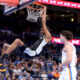 San Antonio Spurs center Victor Wembanyama, left, dunks next to Oklahoma City Thunder guard Josh Giddey, right, in the first half of a preseason NBA basketball game Monday, Oct. 9, 2023, in Oklahoma City. (AP Photo/Sarah Phipps)