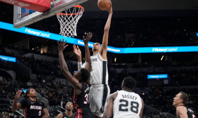 San Antonio Spurs center Victor Wembanyama (1) scores over Miami Heat center Thomas Bryant (31) during the second half of a preseason NBA basketball game in San Antonio, Friday, Oct. 13, 2023. (AP Photo/Eric Gay)