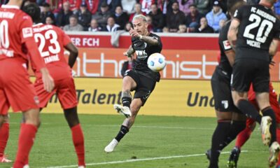 Augsburg's Philip Tietz takes a shot on goal during the German Bundesliga soccer match between FC Augsburg and 1. FC Heidenheim at the Voith-Arena in Heidenheim, Germany, Sunday, Oct. 22, 2023. (Bernd Wei'brod/dpa via AP)