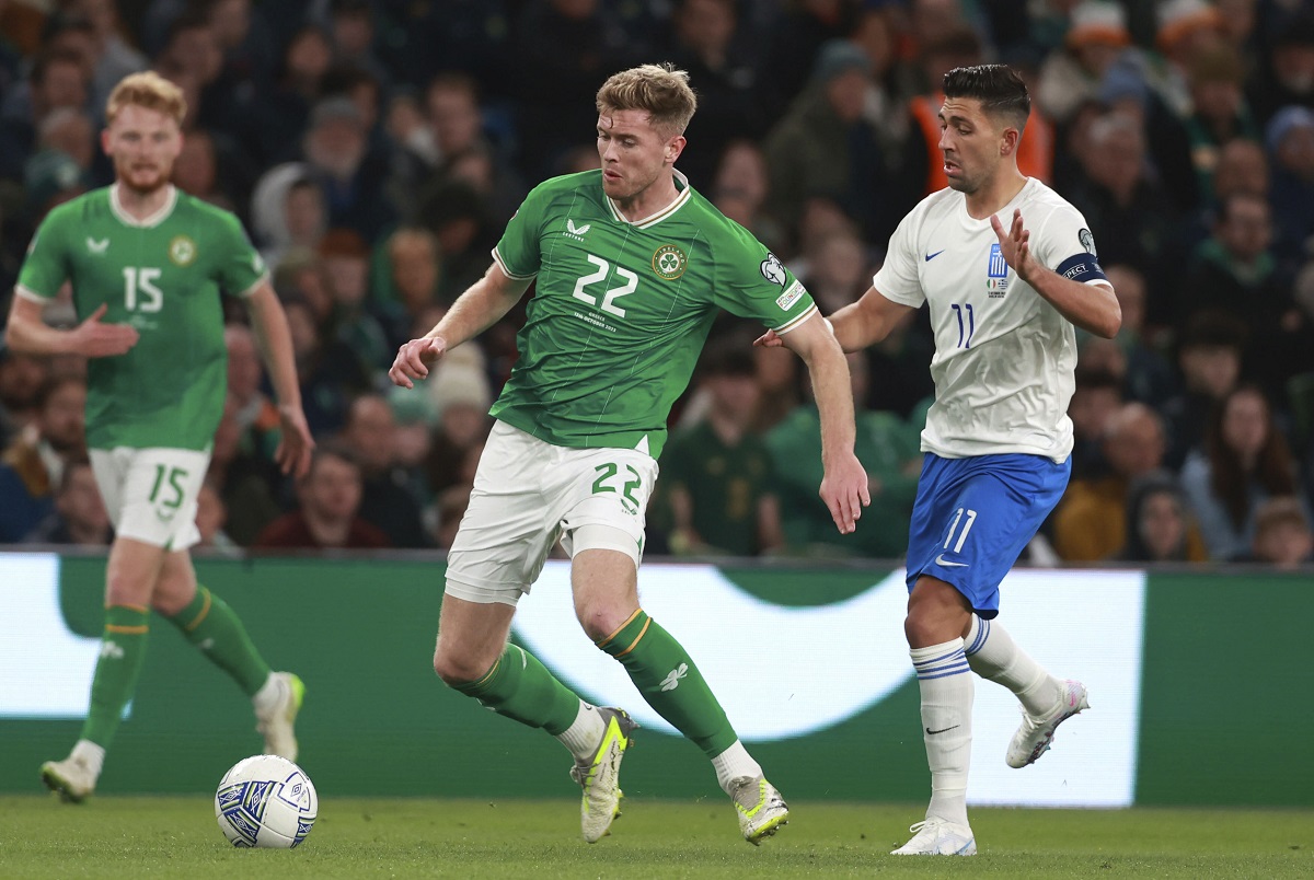 Republic of Ireland's Nathan Collins and Greece's Anastasios Bakasetas, right, battle for the ball during the Euro 2024 qualifying Group B soccer match between Ireland and Greece at the Aviva Stadium, Dublin, Friday Oct. 13, 2023. (Liam McBurney/PA via AP)