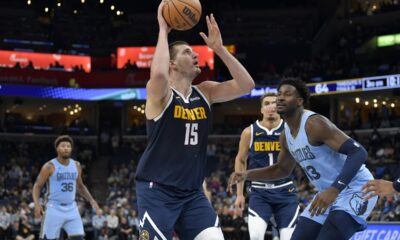 Denver Nuggets center Nikola Jokic (15) looks to shoot against Memphis Grizzlies forward Jaren Jackson Jr. (13) during the second half of an NBA basketball game Friday, Oct. 27, 2023, in Memphis, Tenn. (AP Photo/Brandon Dill)