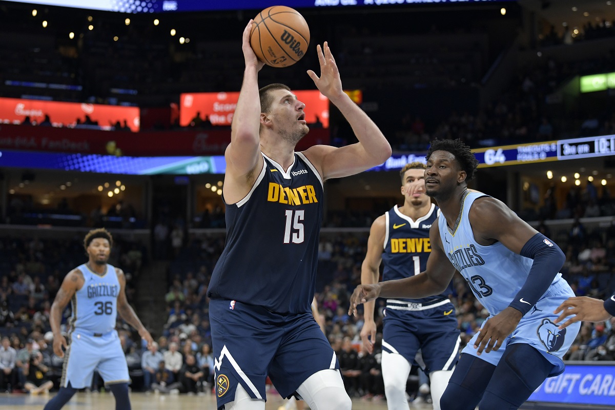 Denver Nuggets center Nikola Jokic (15) looks to shoot against Memphis Grizzlies forward Jaren Jackson Jr. (13) during the second half of an NBA basketball game Friday, Oct. 27, 2023, in Memphis, Tenn. (AP Photo/Brandon Dill)