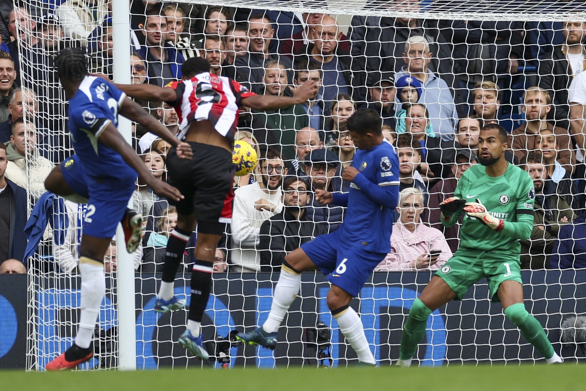 Brentford's Ethan Pinnock, second left, scores his side's opening goal during the English Premier League soccer match between Chelsea and Brentford at Stamford Bridge stadium in London, Saturday, Oct. 28, 2023. (AP Photo/Ian Walton)