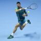 Serbia's Novak Djokovic plays a forehand return to Spain's Carlos Alcaraz during their singles semifinal tennis match of the ATP World Tour Finals at the Pala Alpitour, in Turin, Italy, Saturday, Nov. 18, 2023. (AP Photo/Antonio Calanni)