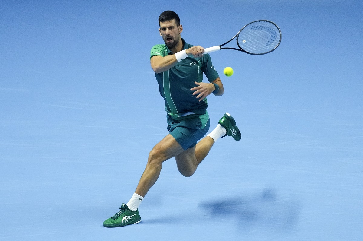 Serbia's Novak Djokovic plays a forehand return to Spain's Carlos Alcaraz during their singles semifinal tennis match of the ATP World Tour Finals at the Pala Alpitour, in Turin, Italy, Saturday, Nov. 18, 2023. (AP Photo/Antonio Calanni)