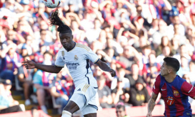 Real Madrid's Eduardo Camavinga heads the ball ahead of Barcelona's Joao Cancelo during the La Liga soccer match between Barcelona and Real Madrid at the Olympic Stadium in Barcelona, Spain, Saturday, Oct. 28, 2023. (AP Photo/Joan Monfort)