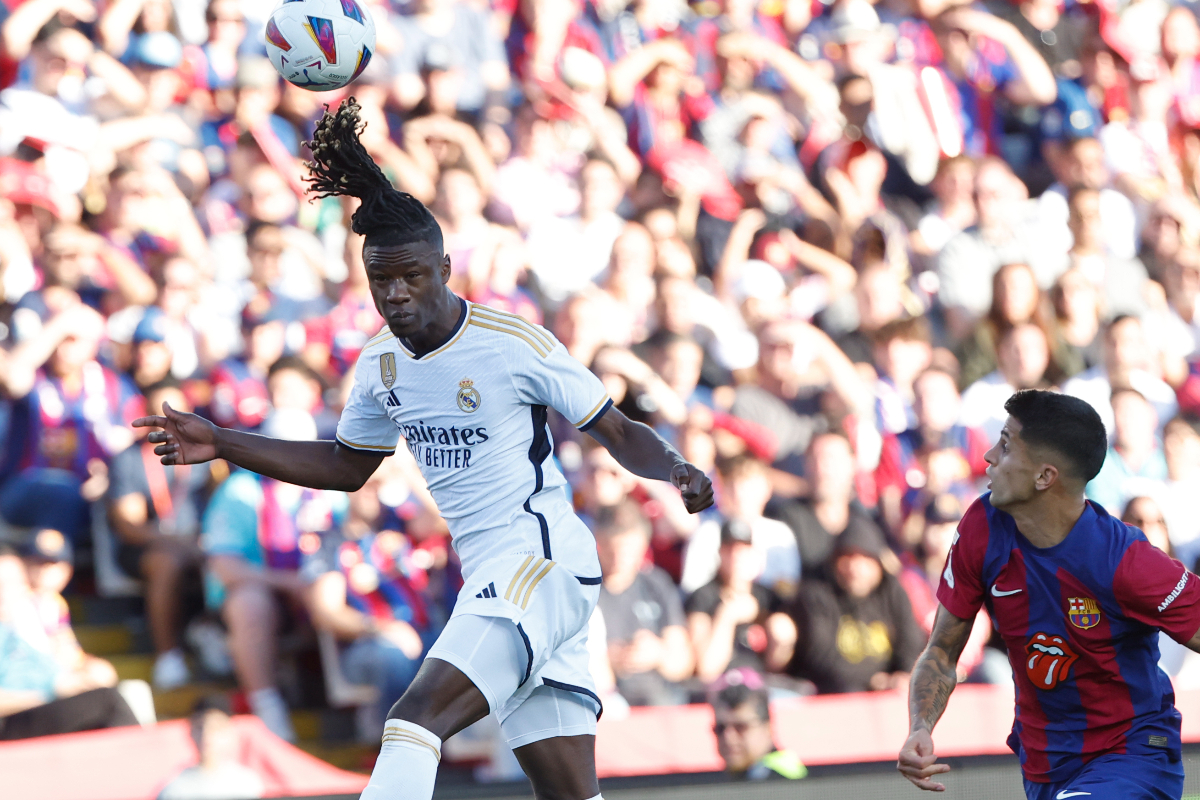 Real Madrid's Eduardo Camavinga heads the ball ahead of Barcelona's Joao Cancelo during the La Liga soccer match between Barcelona and Real Madrid at the Olympic Stadium in Barcelona, Spain, Saturday, Oct. 28, 2023. (AP Photo/Joan Monfort)