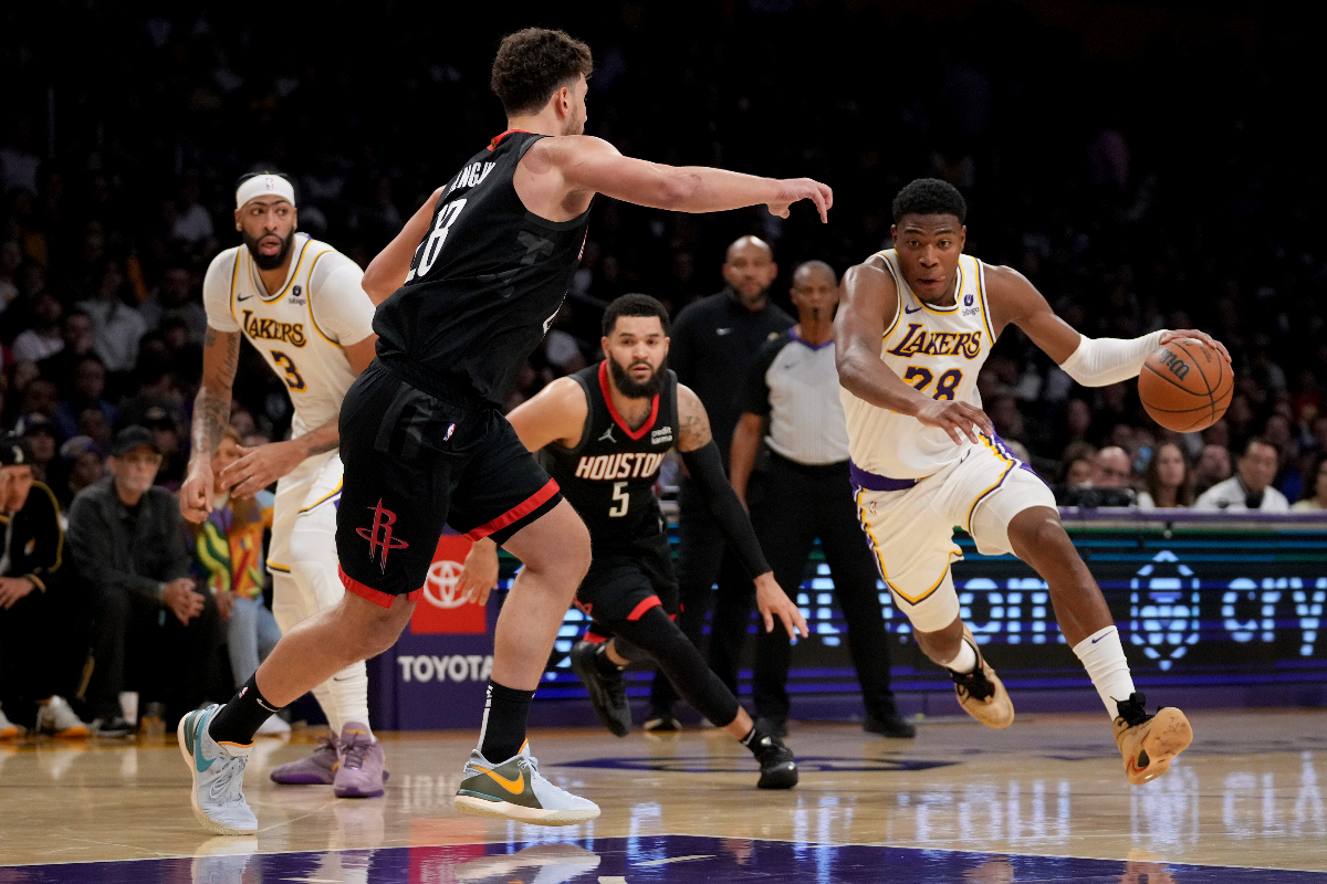 Los Angeles Lakers forward Rui Hachimura (28) drives against Houston Rockets center Alperen Sengun (28) during the second half of an NBA basketball game in Los Angeles, Sunday, Nov. 19, 2023. (AP Photo/Eric Thayer)