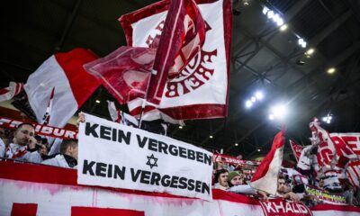 Freiburg's fans hold a poster with the inscription "No forgiveness - no forgetting" during the Europa League Group A soccer match between SC Freiburg and TSC Backa Topola in Freiburg, Germany, Thursday, Nov. 9, 2023. (Tom Weller/dpa via AP)