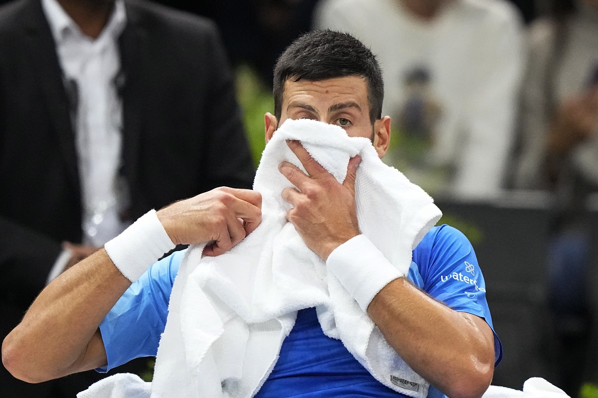 Serbia's Novak Djokovic wipes her face with a towel during the quarterfinal match against Denmark's Holger Rune at the Paris Masters tennis tournament, at the Accor Arena in Paris, Friday, Nov. 3, 2023. (AP Photo/Michel Euler)