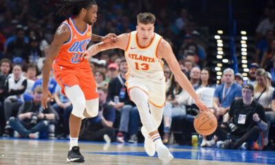 Atlanta Hawks guard Bogdan Bogdanovic (13) pushes past Oklahoma City Thunder guard Cason Wallace, left, in the first half of an NBA basketball game, Monday, Nov. 6, 2023, in Oklahoma City. (AP Photo/Kyle Phillips)