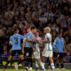Argentina's Lionel Messi holds back Uruguay's Mathias Olivera, as he argues with Argentina's Rodrigo De Paul, during a qualifying soccer match for the FIFA World Cup 2026 at La Bombonera stadium in Buenos Aires, Argentina, Thursday, Nov. 16, 2023. (AP Photo/Gustavo Garello)