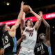 Miami Heat guard Jaime Jaquez Jr. (11) shoots against Atlanta Hawks guard Bogdan Bogdanovic (13) and center Clint Capela (15) during the second half of an NBA basketball game, Saturday, Nov. 11, 2023, in Atlanta. The Miami Heat won 117-109. (AP Photo/Mike Stewart)