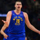 Denver Nuggets center Nikola Jokic disputes a non-call with an official in the first half of an NBA basketball game against the Cleveland Cavaliers, Sunday, Nov. 19, 2023, in Cleveland. (AP Photo/David Dermer)
