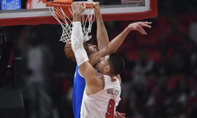 Chicago Bulls' Nikola Vucevic (9) dunks against Oklahoma City Thunder's Chet Holmgren, left, during the first half of an NBA basketball game Wednesday, Oct. 25, 2023, in Chicago. (AP Photo/Paul Beaty)