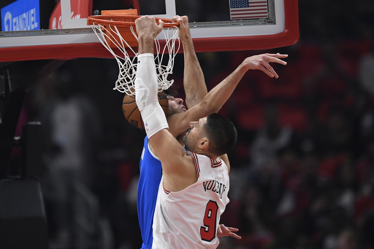 Chicago Bulls' Nikola Vucevic (9) dunks against Oklahoma City Thunder's Chet Holmgren, left, during the first half of an NBA basketball game Wednesday, Oct. 25, 2023, in Chicago. (AP Photo/Paul Beaty)