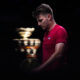 Serbia's Miomir Kecmanovic walks on the court, with the Davis Cup on the background, during a Davis Cup quarter-final tennis match between Serbia and United Kingdom in Malaga, Spain, Thursday, Nov. 23, 2023. (AP Photo/Manu Fernandez)