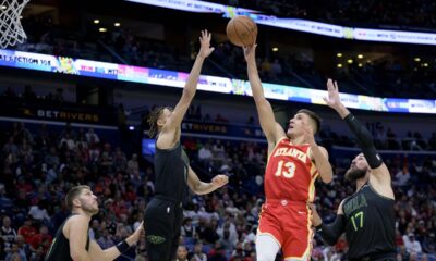 Atlanta Hawks guard Bogdan Bogdanovic (13) shoots against New Orleans Pelicans guard Dyson Daniels, center left, during the second half of an NBA basketball game against the New Orleans Pelicans in New Orleans, Saturday, Nov. 4, 2023. (AP Photo/Matthew Hinton)