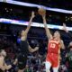 Atlanta Hawks guard Bogdan Bogdanovic (13) shoots against New Orleans Pelicans guard Dyson Daniels, center left, during the second half of an NBA basketball game against the New Orleans Pelicans in New Orleans, Saturday, Nov. 4, 2023. (AP Photo/Matthew Hinton)
