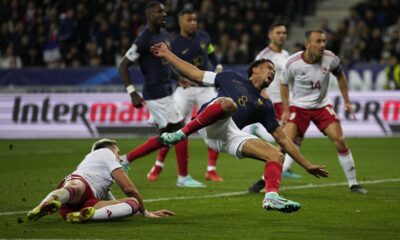 Gibraltar's Ethan Santos, left, fouls France's Warren Zaire-Emery for a red card during the Euro 2024 group B qualifying soccer match between France and Gibraltar in Nice, France, Saturday, Nov. 18, 2023. (AP Photo/Daniel Cole)