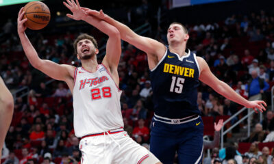 Houston Rockets center Alperen Sengun (28) pulls in a rebound next to Denver Nuggets center Nikola Jokic (15) during the second half of an NBA basketball In-Season Tournament game Friday, Nov. 24, 2023, in Houston. (AP Photo/Michael Wyke)