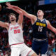 Houston Rockets center Alperen Sengun (28) pulls in a rebound next to Denver Nuggets center Nikola Jokic (15) during the second half of an NBA basketball In-Season Tournament game Friday, Nov. 24, 2023, in Houston. (AP Photo/Michael Wyke)