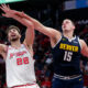 Houston Rockets center Alperen Sengun (28) pulls in a rebound next to Denver Nuggets center Nikola Jokic (15) during the second half of an NBA basketball In-Season Tournament game Friday, Nov. 24, 2023, in Houston. (AP Photo/Michael Wyke)