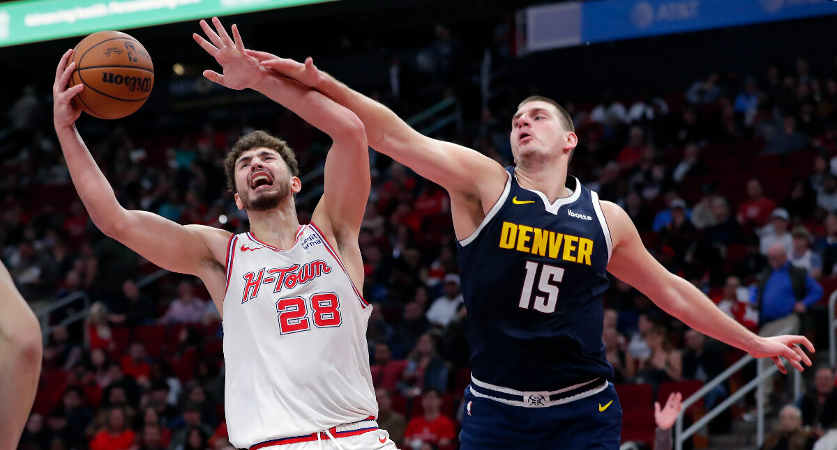 Houston Rockets center Alperen Sengun (28) pulls in a rebound next to Denver Nuggets center Nikola Jokic (15) during the second half of an NBA basketball In-Season Tournament game Friday, Nov. 24, 2023, in Houston. (AP Photo/Michael Wyke)