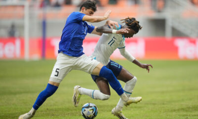 England's Joel Ndala, right, battles for the ball against Uzbekistan's Azizbek Tulkunbekov during their FIFA U-17 World Cup round of 16 soccer match at Jakarta International Stadium in Jakarta, Indonesia, Wednesday, Nov. 22, 2023. (AP Photo/Dita Alangkara)