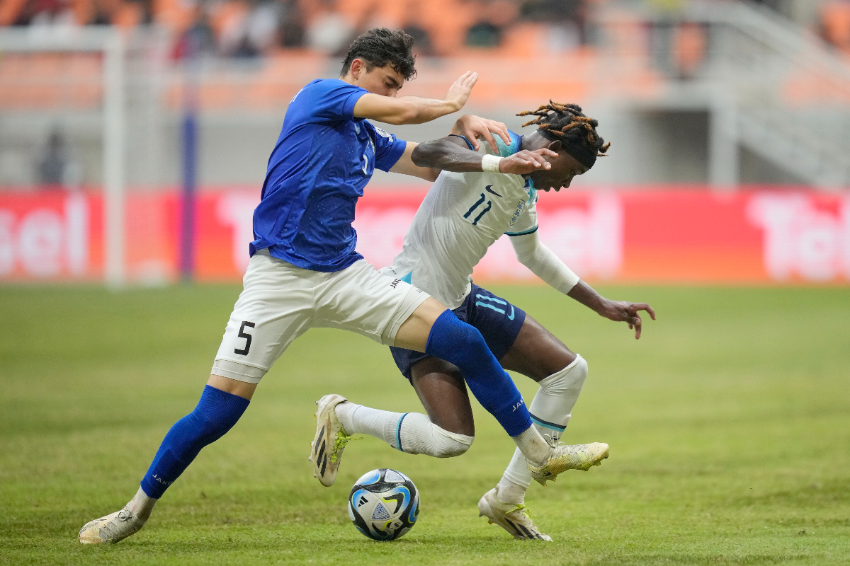 England's Joel Ndala, right, battles for the ball against Uzbekistan's Azizbek Tulkunbekov during their FIFA U-17 World Cup round of 16 soccer match at Jakarta International Stadium in Jakarta, Indonesia, Wednesday, Nov. 22, 2023. (AP Photo/Dita Alangkara)