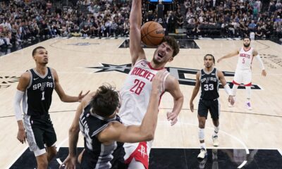 Houston Rockets center Alperen Sengun (28) scores over San Antonio Spurs forward Zach Collins (23) during overtime in an NBA basketball game in San Antonio, Friday, Oct. 27, 2023. (AP Photo/Eric Gay)