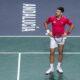 Serbia's Novak Djokovic reacts during his match with his teammate Miomir Kecmanovic against Italy's Jannik Sinner and Lorenzo Sonego during a Davis Cup semi-final doubles tennis match between Italy and Serbia in Malaga, Spain, Saturday, Nov. 25, 2023. (AP Photo/Manu Fernandez)