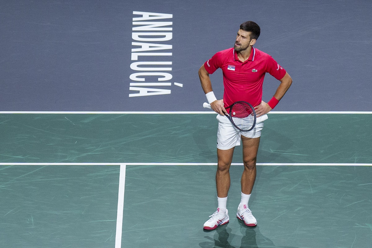 Serbia's Novak Djokovic reacts during his match with his teammate Miomir Kecmanovic against Italy's Jannik Sinner and Lorenzo Sonego during a Davis Cup semi-final doubles tennis match between Italy and Serbia in Malaga, Spain, Saturday, Nov. 25, 2023. (AP Photo/Manu Fernandez)